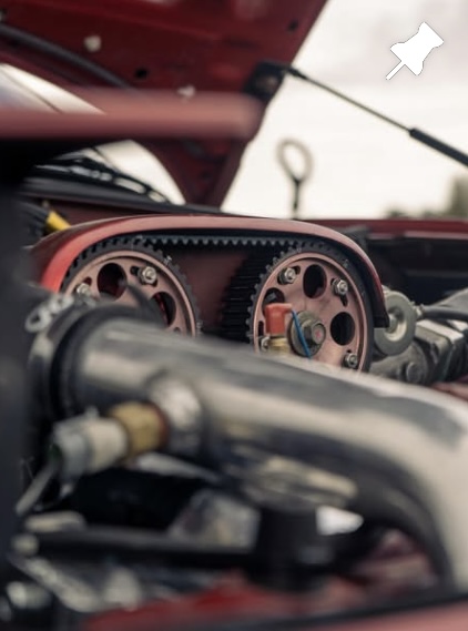 Close-up of copper cam gears and timing belt in a performance engine bay