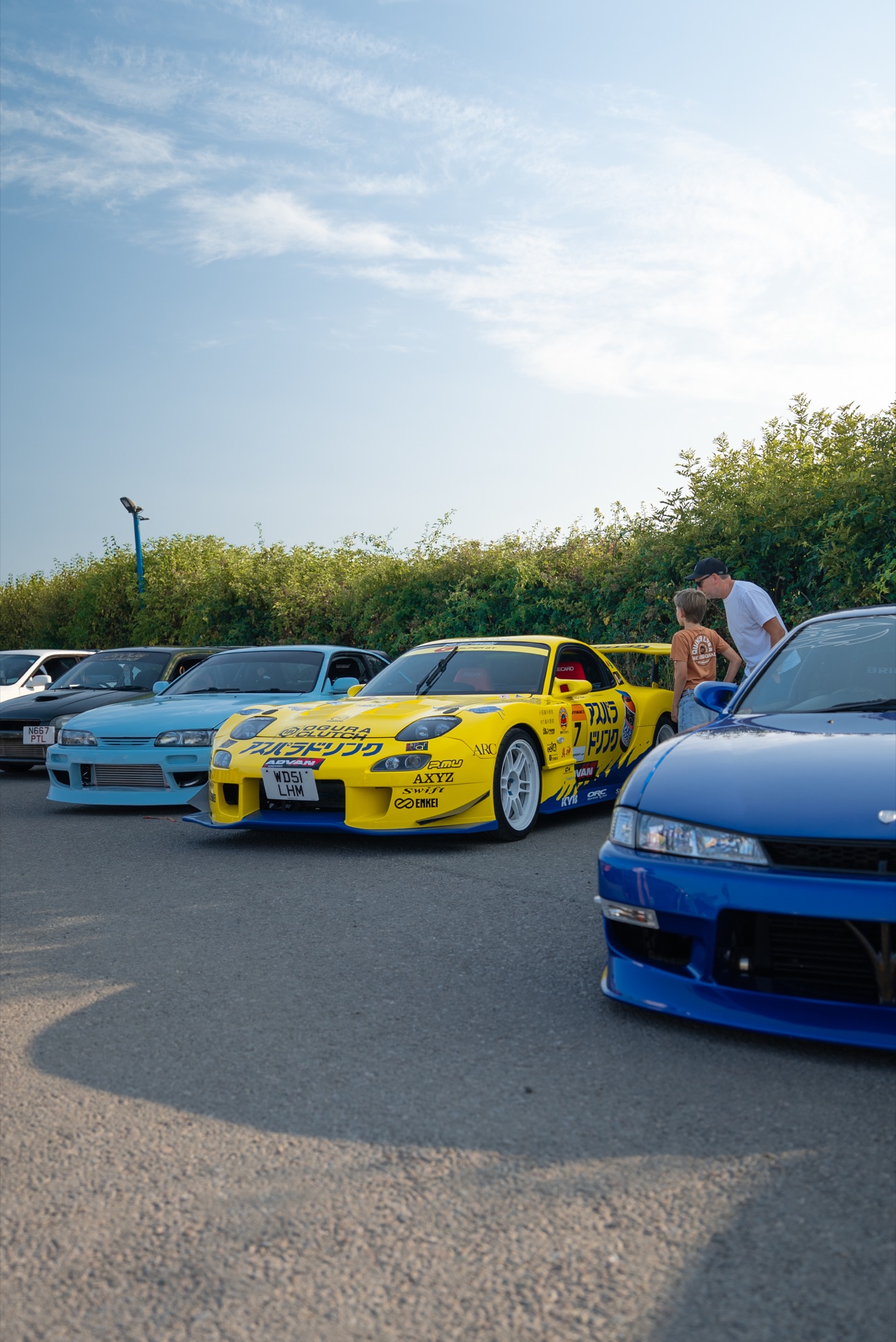 Yellow Mazda RX-7 FD on the paddock among other cars